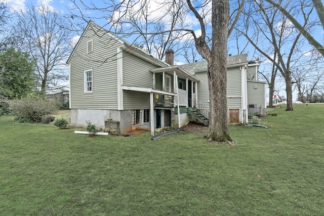 rear view of house with a yard