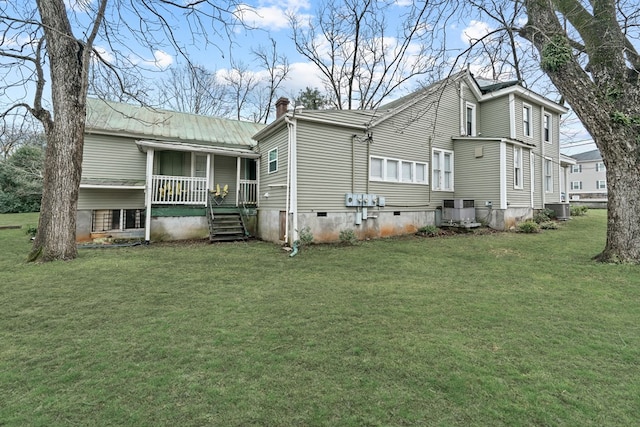 rear view of house featuring a porch, cooling unit, and a lawn