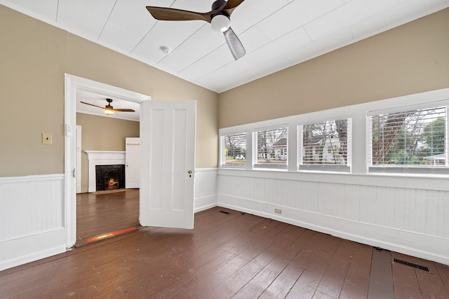 unfurnished room featuring vaulted ceiling, dark hardwood / wood-style flooring, and ceiling fan