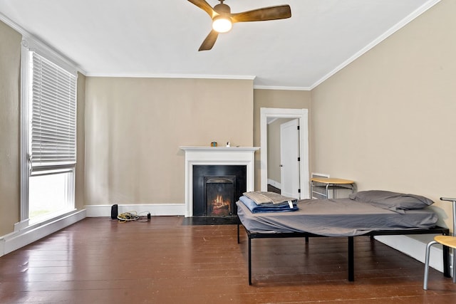 sitting room with ceiling fan, ornamental molding, and dark hardwood / wood-style floors