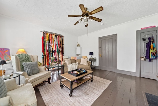 living room featuring wood-type flooring, ornamental molding, ceiling fan, and a textured ceiling