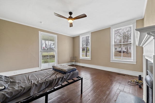 bedroom featuring crown molding, ceiling fan, and dark hardwood / wood-style flooring