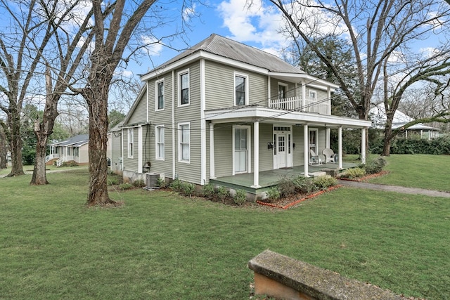 view of side of home featuring central AC, a lawn, a balcony, and covered porch