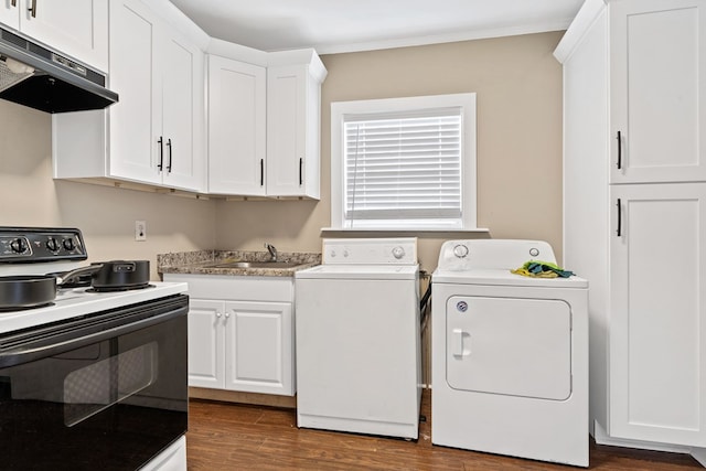 washroom featuring dark hardwood / wood-style floors, ornamental molding, sink, and washing machine and dryer