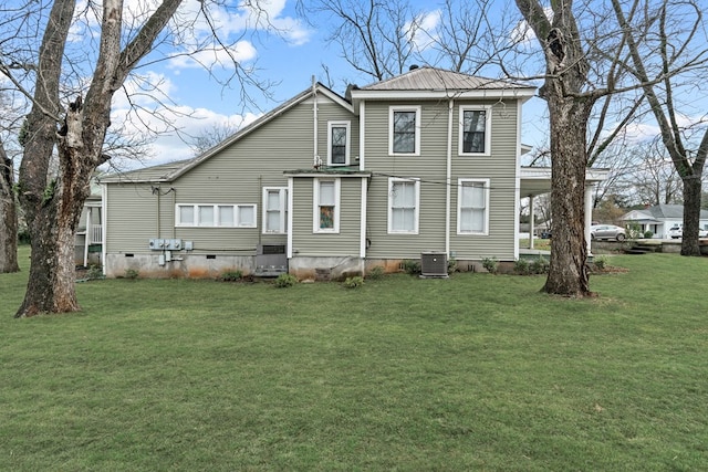 rear view of house featuring a lawn and central air condition unit