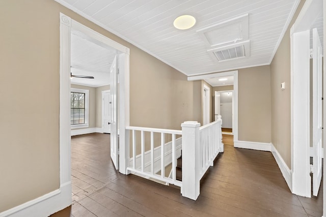 corridor with dark hardwood / wood-style flooring and crown molding