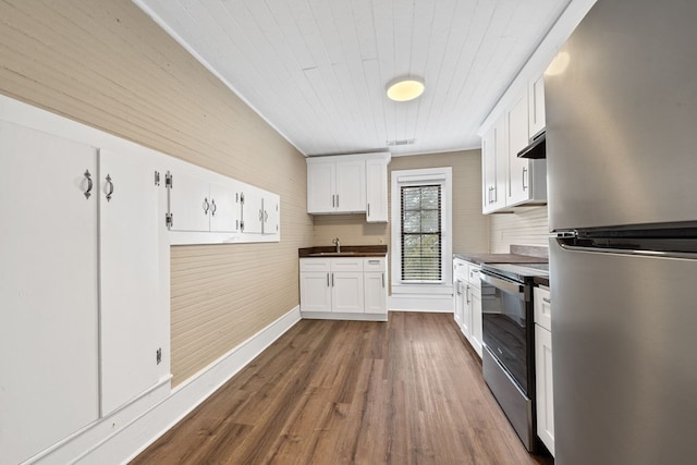 kitchen with white cabinetry, sink, stainless steel appliances, and dark hardwood / wood-style floors