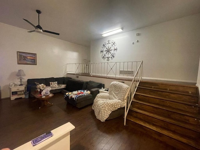 living area featuring stairway, a ceiling fan, and wood finished floors