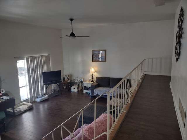 living area featuring visible vents, wood finished floors, and a ceiling fan