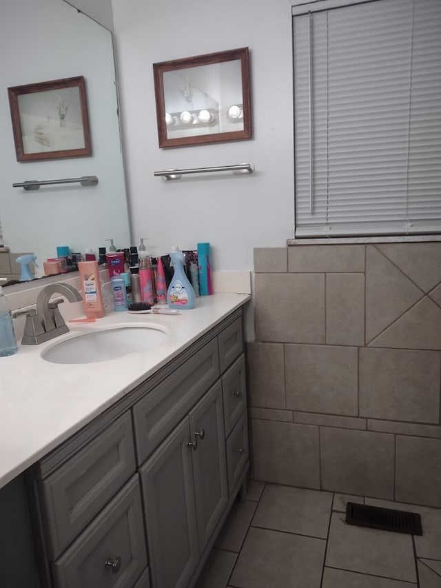 bathroom with visible vents, vanity, and tile patterned floors