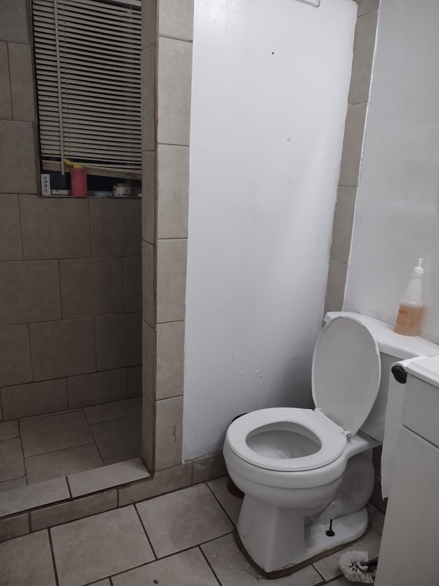 bathroom with toilet and tile patterned floors