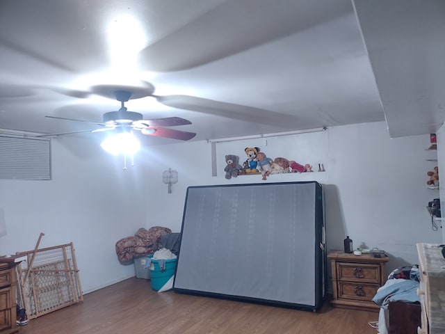 interior space with ceiling fan and wood finished floors