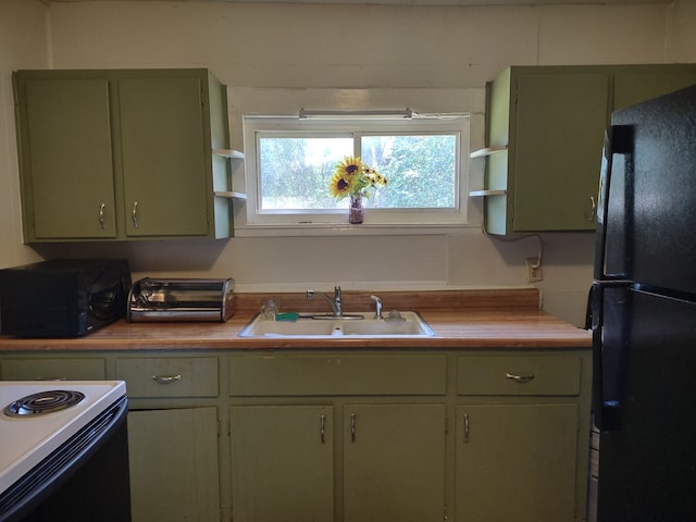 144 Bell Ave, Milledgeville, GA 31061 - kitchen featuring black appliances, green cabinetry, a sink, open shelves, and butcher block countertops