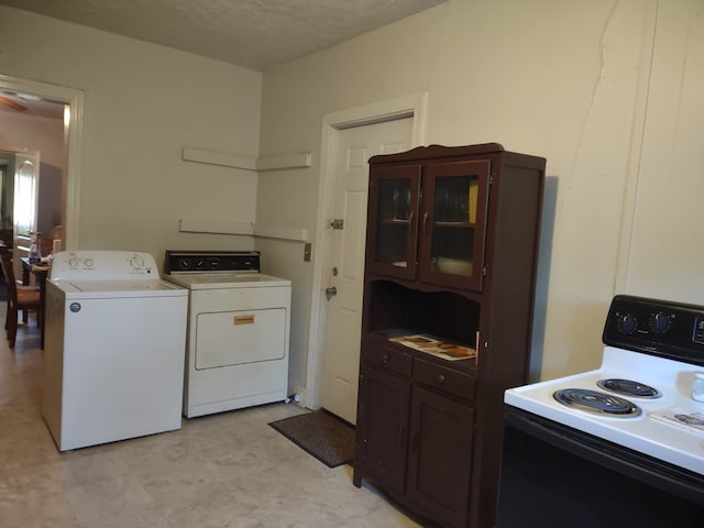 144 Bell Ave, Milledgeville, GA 31061 - laundry room with light floors, a textured ceiling, and separate washer and dryer