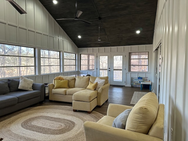 living room with ceiling fan, hardwood / wood-style floors, and high vaulted ceiling