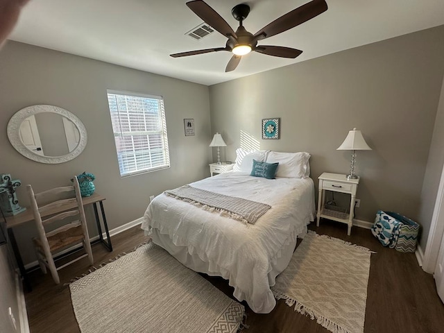 bedroom with ceiling fan and dark hardwood / wood-style flooring