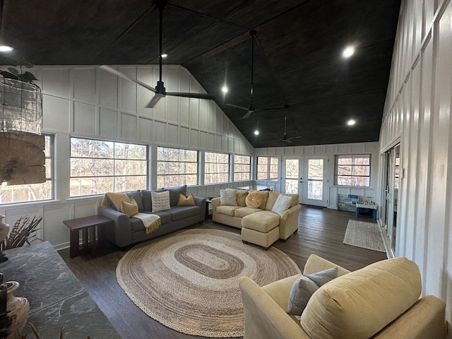 living room featuring high vaulted ceiling, ceiling fan, dark hardwood / wood-style floors, and a wealth of natural light