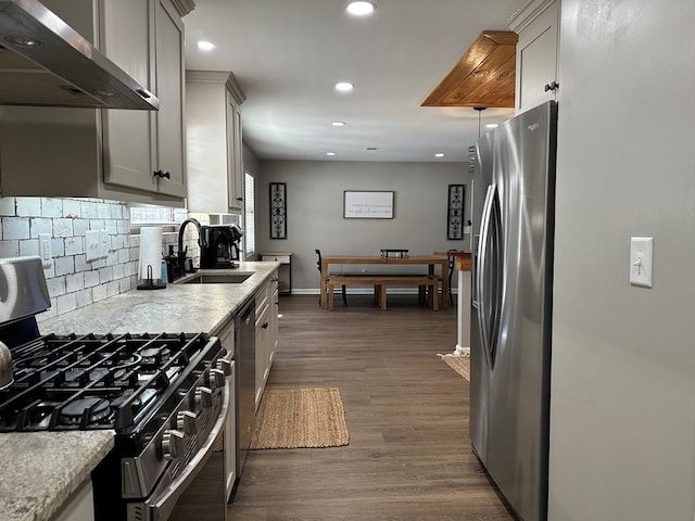 kitchen featuring gray cabinets, range hood, sink, dark wood-type flooring, and appliances with stainless steel finishes