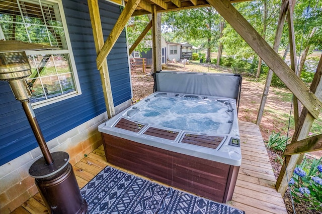 deck featuring a covered hot tub