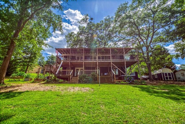 back of property with a yard and a wooden deck