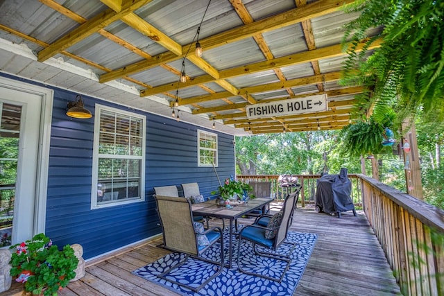 deck with outdoor dining area and area for grilling