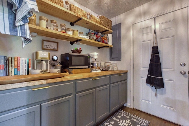 bathroom featuring a textured ceiling and wood finished floors