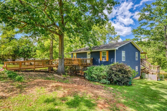 exterior space with a front lawn and a wooden deck