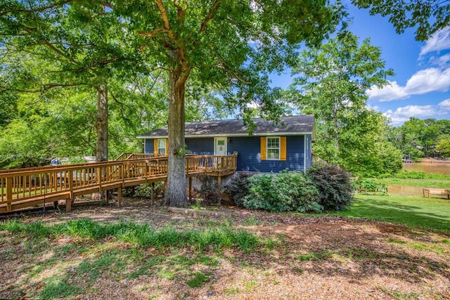 view of front of house featuring a front yard and a wooden deck