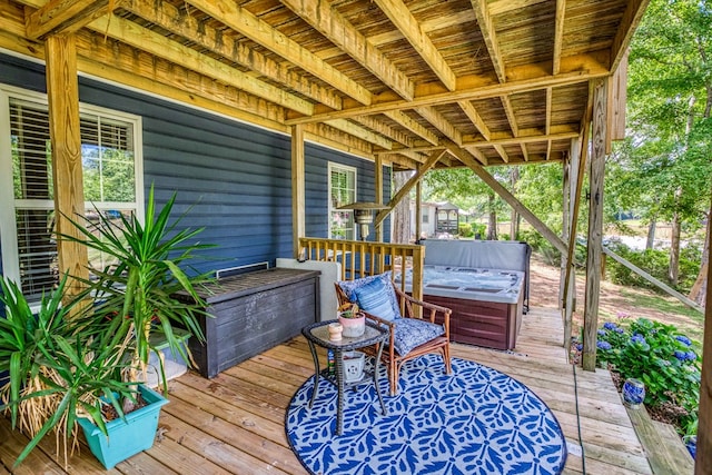 wooden deck featuring a hot tub