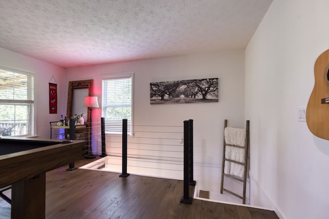 rec room featuring dark wood finished floors, a textured ceiling, baseboards, and billiards