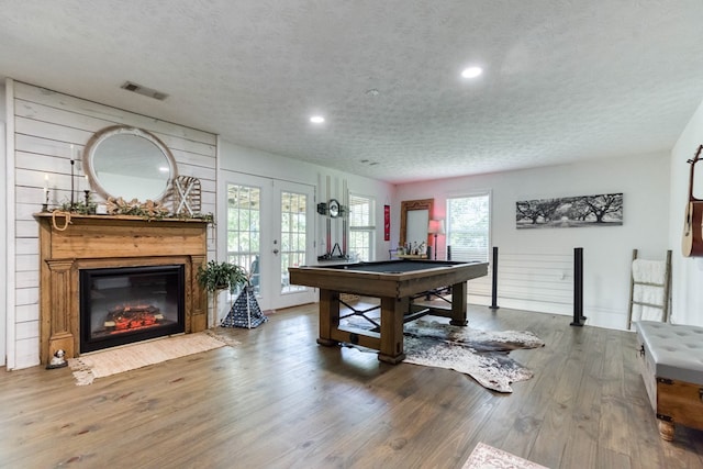 game room featuring visible vents, wood finished floors, pool table, a textured ceiling, and french doors