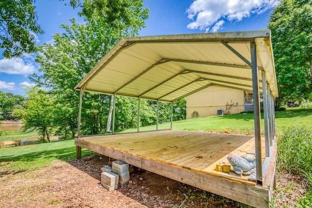 wooden terrace with a yard and a carport