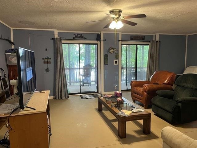 living room featuring ceiling fan, a healthy amount of sunlight, and a textured ceiling