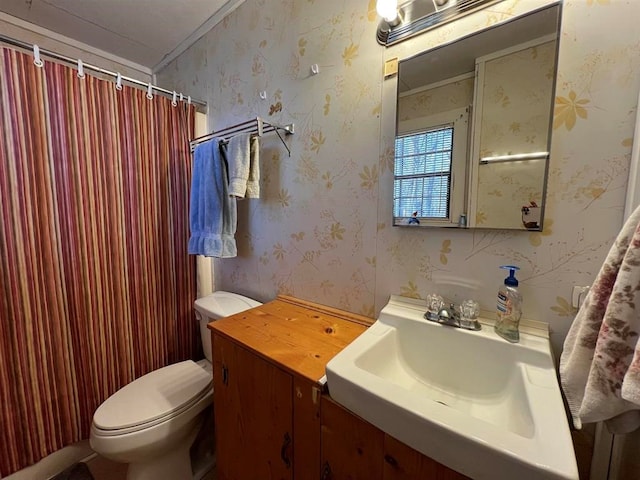 bathroom featuring a shower with curtain, sink, crown molding, and toilet