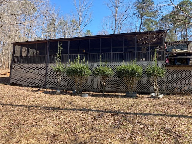 rear view of property with a sunroom