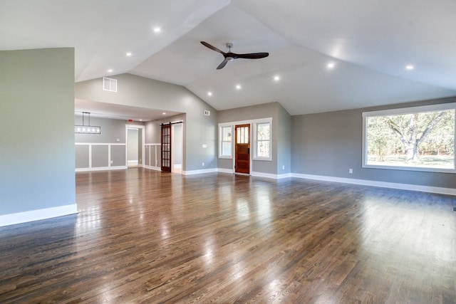 unfurnished living room featuring ceiling fan, lofted ceiling, and dark wood-type flooring