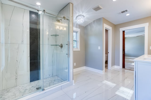 bathroom featuring vanity, toilet, and walk in shower