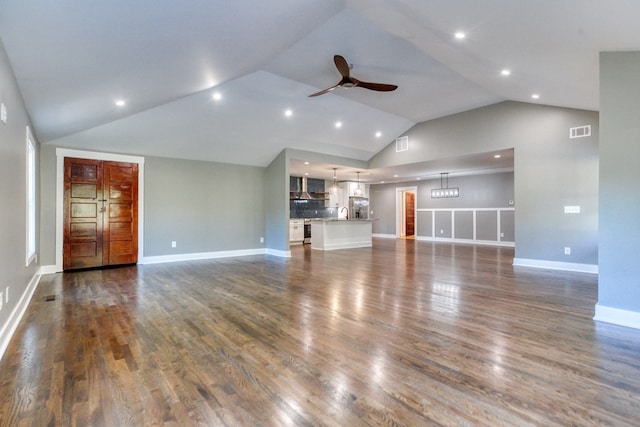 unfurnished living room with ceiling fan, dark hardwood / wood-style flooring, and lofted ceiling