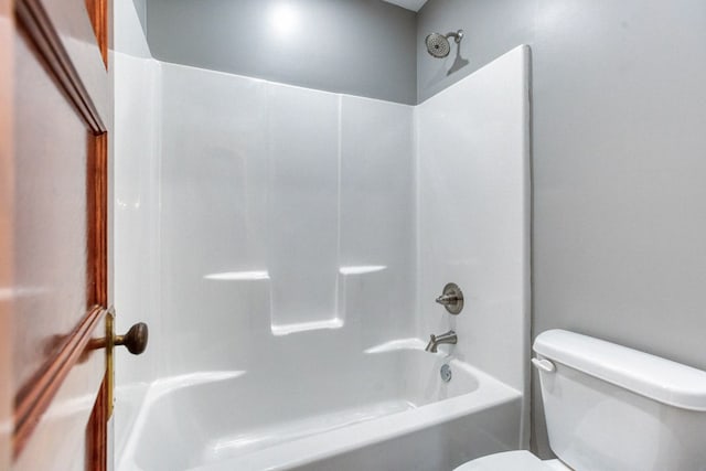 bathroom featuring shower / bathtub combination and toilet