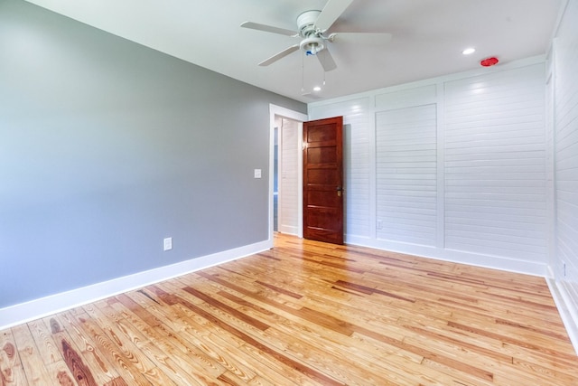 spare room with light wood-type flooring and ceiling fan