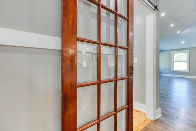 room details with hardwood / wood-style floors and a barn door