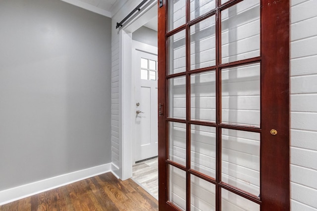 interior space featuring dark hardwood / wood-style flooring and a barn door