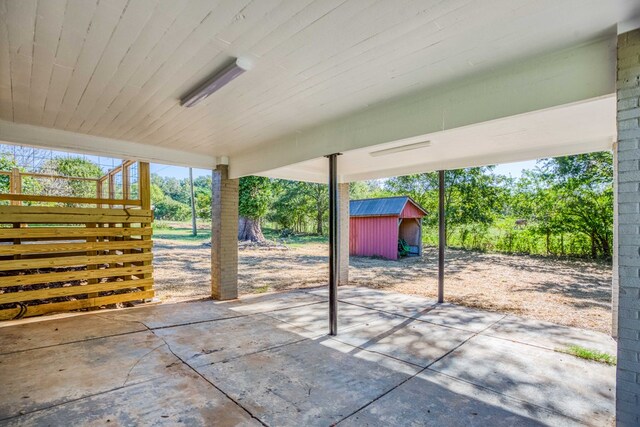 view of patio featuring a shed