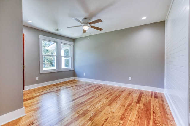 spare room with ceiling fan and light wood-type flooring