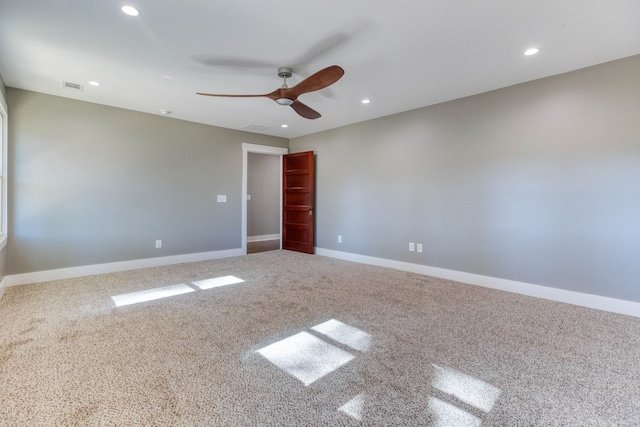 spare room featuring carpet floors and ceiling fan