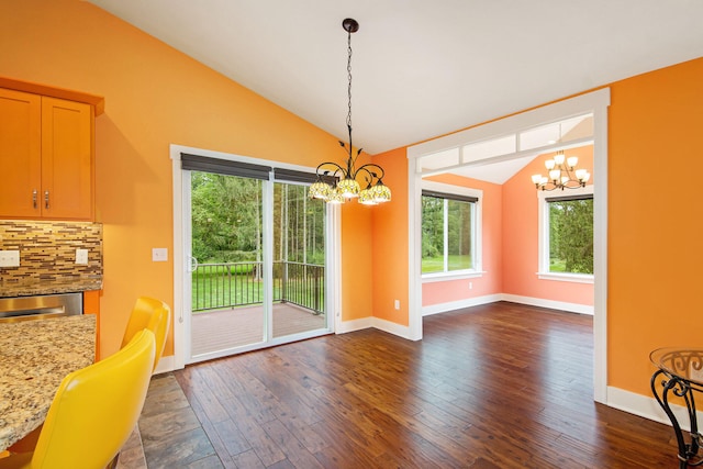 unfurnished dining area featuring lofted ceiling, dark wood-type flooring, and a notable chandelier