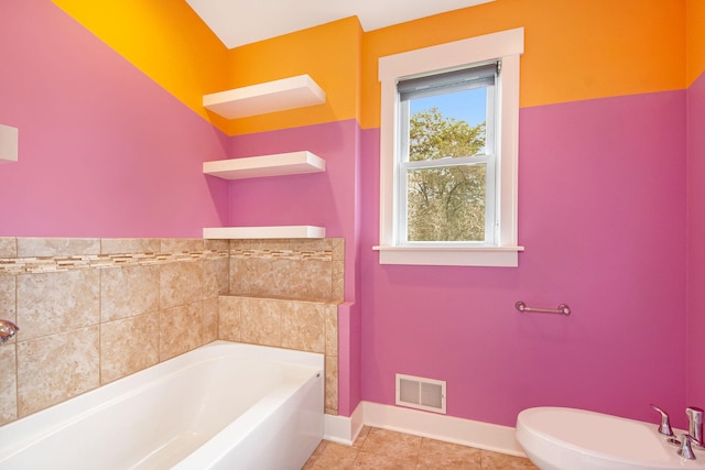 bathroom with a bath, toilet, and tile patterned flooring