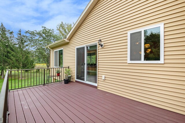 wooden terrace featuring a yard