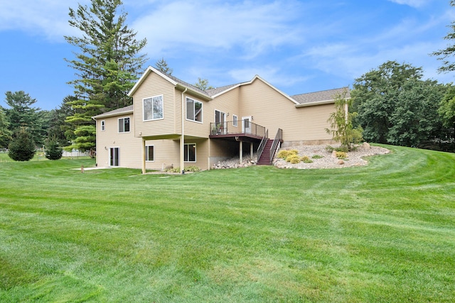 back of house featuring a lawn and a wooden deck