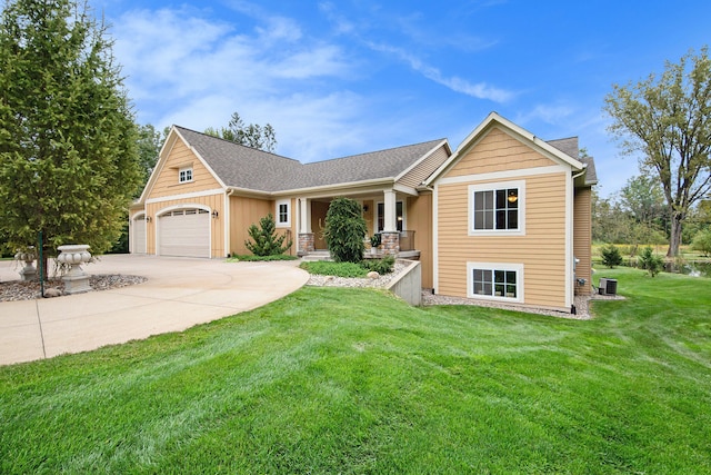 view of front facade with a garage, a front lawn, and central AC